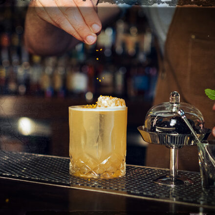 gold rush cocktail being served