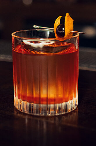 old fashioned cocktail being served