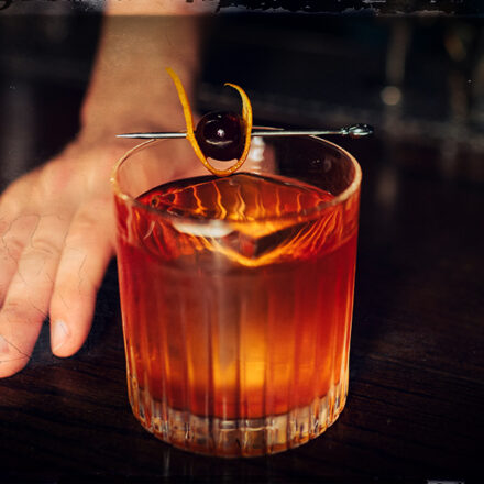 old fashioned cocktail being served