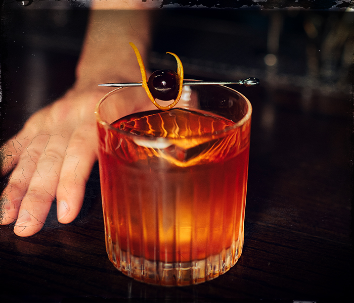 old fashioned cocktail being served
