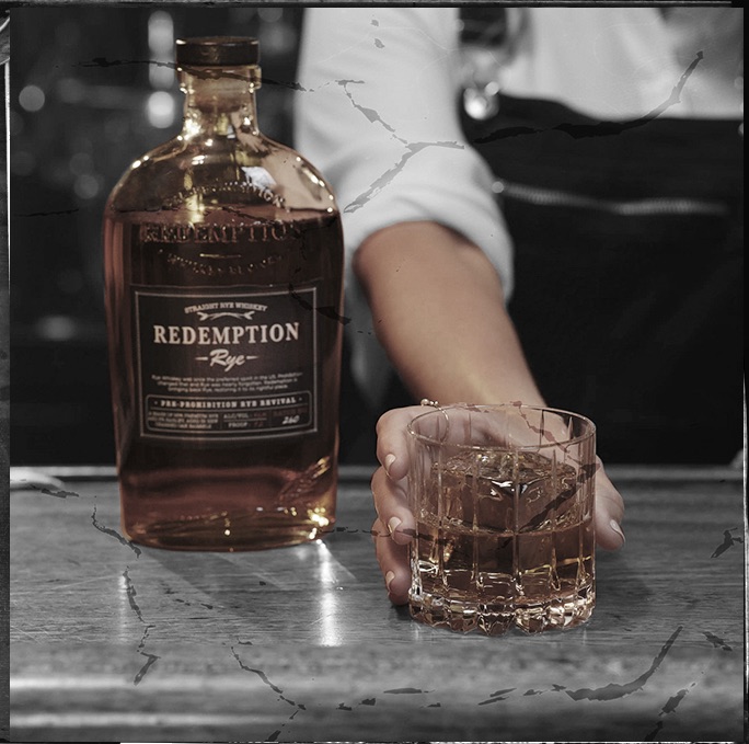 bartender with whiskey in glass